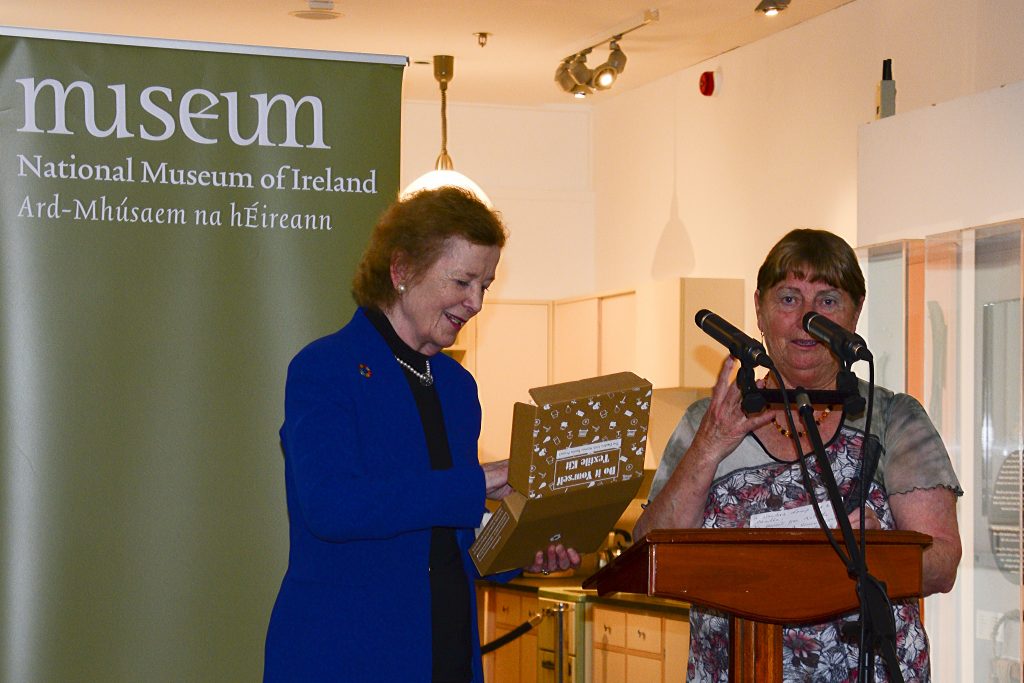 Maura McGuinness presenting Mary Robinson with a textile craft kit