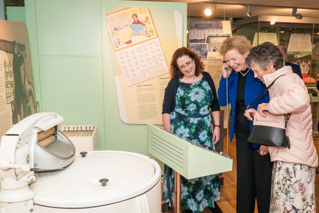 Sorcha O'Brien and interview participant Brigid O'Brien showing Mary Robinson the oral histories