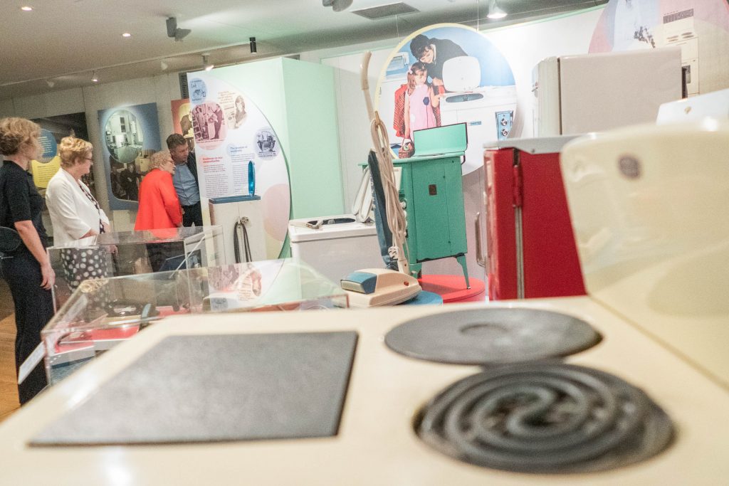 Interview participants inspecting the Kitchen Power exhibition